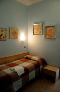 Postel nebo postele na pokoji v ubytování Albergo Casa Lupi