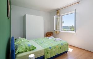 a bedroom with a bed and a window at House Arkulin by Villas Guide in Gruda +22 photos