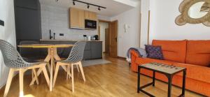 a living room with a table and chairs and a couch at Apartamento Vega del Cares by Casas de Los Picos in Arenas de Cabrales +12 photos
