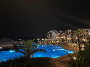 a view of a swimming pool at night at Seaside Oasis Apartment in Lozenets