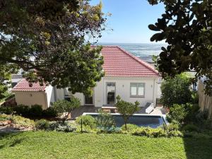 a house with a view of the ocean at Sweet Home Bakoven Beach in Cape Town