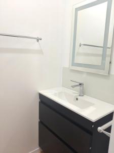 a bathroom with a sink and a mirror at Cozy Bedroom in Tauranga in Tauranga