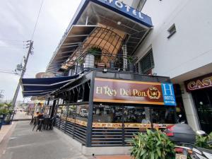a restaurant with a sign on the side of a building at Hotel Bahia in Villavicencio