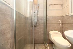 a bathroom with a toilet and a glass shower at RAP Appart 302 avec piscine in Douala +1 photo