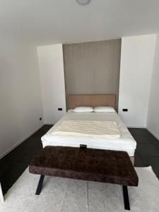 a small bedroom with a bed with a brown rug at Residence Deluxe Ljubijankici in Ljubijankići