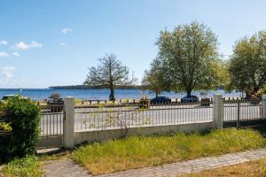 a fence in front of a body of water at Villa Etchola - Moutchic -3 étoiles in Lacanau