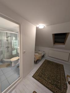 a bathroom with a toilet and a sink and a mirror at Casa Daya in Topliţa