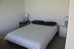 a small bedroom with a bed and two night stands at Brook in Walgett