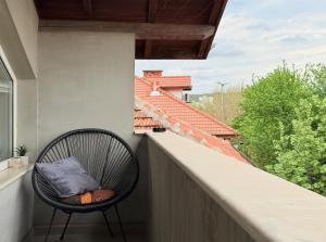 a chair sitting on the balcony of a house at Corner house apartment in Montana