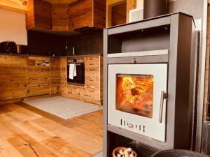 a kitchen with an oven with a fire in it at Chalet Herbst in Lofer
