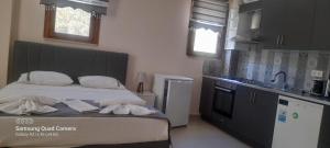 a small kitchen with a bed in a room at Söğüt Butik Apart in Marmaris