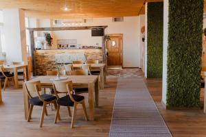 a restaurant with tables and chairs in a room at Hýbadlo in Liptovský Hrádok