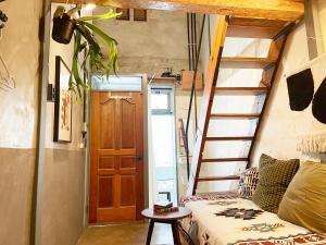 a room with a bed and a staircase and a door at Hongdae Guesthouse Pajamaparty in Seoul