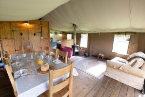 a dining room and living room with a tent at Dawn Chorus Holidays in Beccles