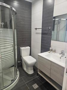 a bathroom with a toilet and a sink and a shower at Island Boutique Hotel in Rhodes Town