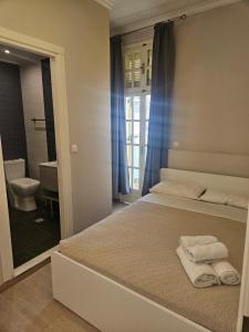 a bedroom with a bed with towels on it at Island Boutique Hotel in Rhodes Town
