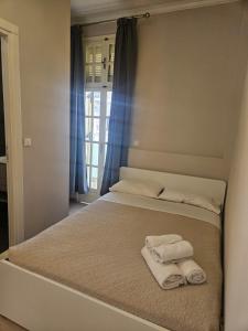 a bed with two towels sitting on top of it at Island Boutique Hotel in Rhodes Town