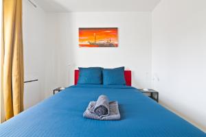 - une chambre avec un lit bleu et une serviette dans l'établissement 1 Bedroom Apartment Quartier Austerlitz Free Netflix, à Paris