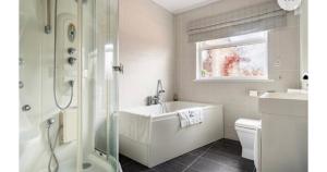 a white bathroom with a tub and a sink at Cullentra House in Cushendall +47 photos
