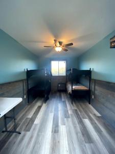 a room with a ceiling fan and wooden floors at Off-Grid Cabin with Fire Pit and Trail Access Nestled in Nature in Sugar Grove, West Virginia in Sugar Grove