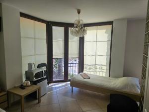 a bedroom with a bed and a tv and a window at Villa Farage in Mielno