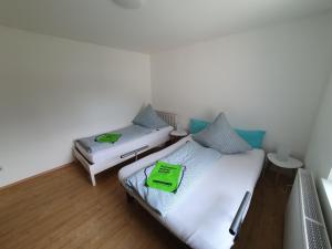 two beds in a room with a green tray on them at Ferienwohnungen Ilona Blick in Kelberg