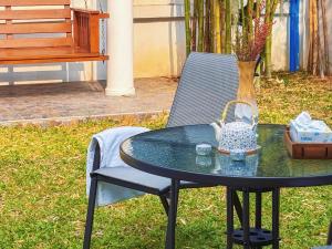a table with a basket on top of it next to a chair at 提供免费汽车使用的含泳池被墅房间 in Chiang Mai