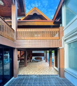 an external view of a house with a patio at 提供免费汽车使用的含泳池被墅房间 in Chiang Mai