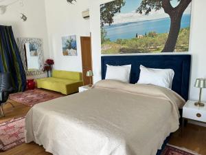 a bedroom with a large bed with a blue headboard at Villa Maranata-5 stars-pool-spa-gym-free parking-privacy in Jesenice +60 photos