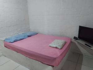Ένα ή περισσότερα κρεβάτια σε δωμάτιο στο Casa pertinho do centro +5 φωτογραφίες