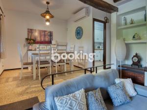 a living room and dining room with a blue couch at Can Niu in Platja  d'Aro