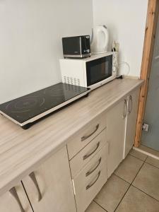 a microwave sitting on top of a counter in a kitchen at Villa Farage in Mielno