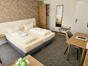 a hotel room with a bed and a table at Gasthof goldener Engel in Kemnath +126 photos