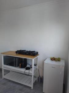 a table with a stove and a refrigerator in a room at 60 On Kosmos in Bellville South