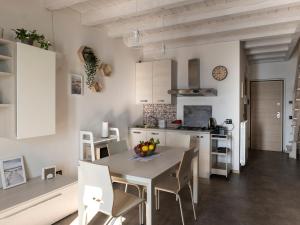 a kitchen and dining room with a table and chairs at Cherubino 2 - Nice 2 floors apartment with pool, terrace and a terrific lake view in Parzanica