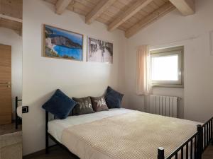 a bedroom with a bed and a window at Cherubino 2 - Nice 2 floors apartment with pool, terrace and a terrific lake view in Parzanica