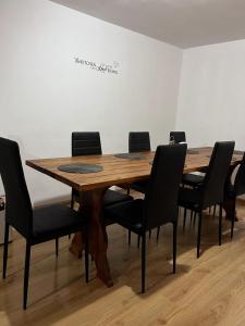 a conference room with a wooden table and chairs at Cabana Muntelui in Munteni