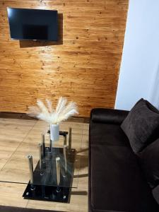 a living room with a couch and a glass table at Cabana Muntelui in Munteni