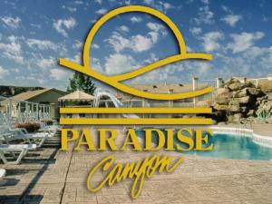 a sign that says paradise cambium next to a pool at Paradise Canyon Golf Resort - Luxury Condo M407 in Lethbridge