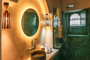 a bathroom with a sink and a shower at Le Palazzo in Essaouira