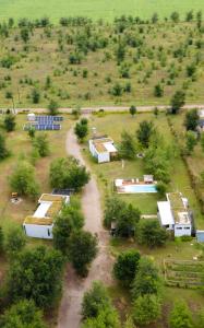 an aerial view of a farm with buildings and trees at Paso Calmo Cabañas in Villa General Belgrano
