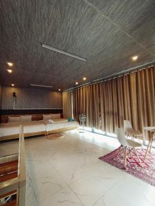 a large room with a bed and a table and chairs at Dốc home in Da Thien