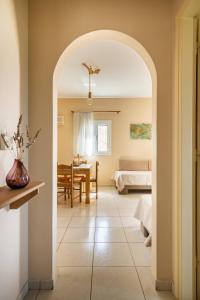 a room with a bedroom and a dining room at Kefalonian Oneira Villas in Mousata