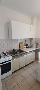 a kitchen with a sink and a stove at Aparmani Đani 2 in Pag +6 photos