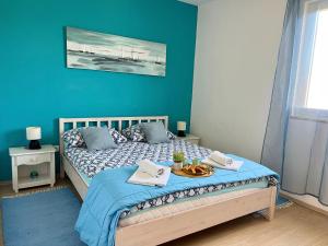 a bedroom with a bed with a tray of food on it at Apartment Leonora in Vinišće