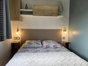 a bedroom with a bed with a colorful comforter at La petite folie in Quiberon +15 photos