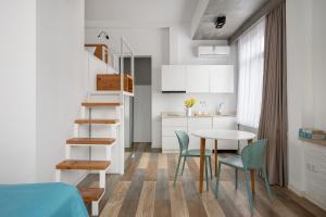 a small kitchen and dining room with a table and chairs at Mariinsky Boutique Hotel in Batumi