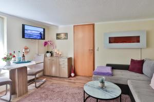 a living room with a couch and a table at Bungalow Konrad in Kühlungsborn