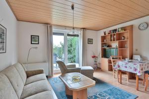 a living room with a couch and a table at FeWo Lavendel in Kröpelin