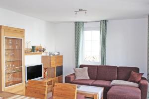 a living room with a couch and a table at Friederike 1 in Nienhagen